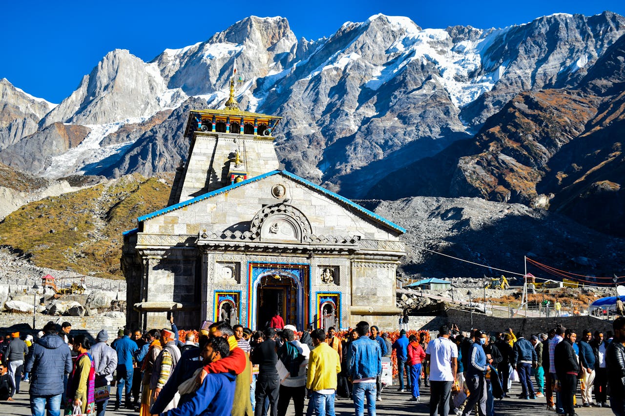Services Crowd gathers at Kedarnath Temple with Himalayas backdrop, showcasing religious significance and stunning landscape.