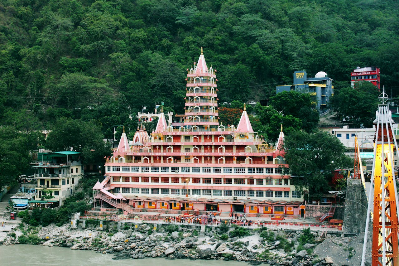 Home Stunning view of Tera Manzil Temple against lush hills in Rishikesh, India.